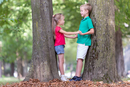 Portrait of two pretty cute children boy and girl standing near 