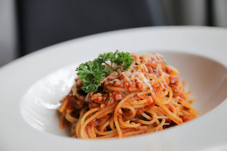 spaghetti bolognese with minced beef and tomato sauce garnished