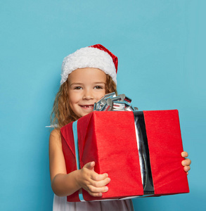  Girl in Santa red hat holding Christmas gift