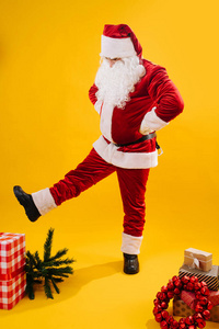 Cheerful Santa Claus in a funny pose, studio shot. 