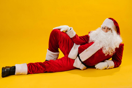 Cheerful Santa Claus in a funny pose, studio shot. 