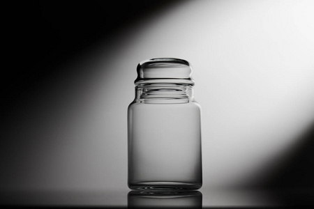 Empty glass jar on a black and white background