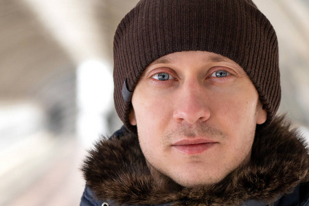 Close up street portrait of a young unshaven European man with g