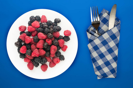  blackberry and raspberry on a white plate. blackberry and raspb