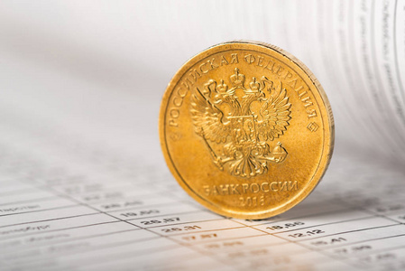 One ruble coin on a summary table 