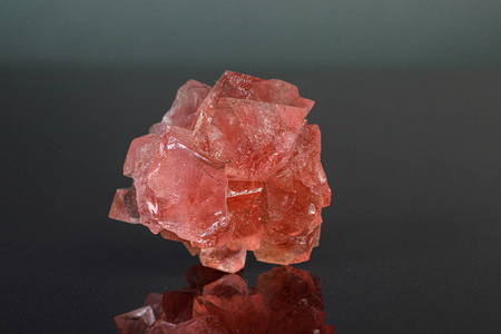 macro mineral stone pink fluorite on a black background 