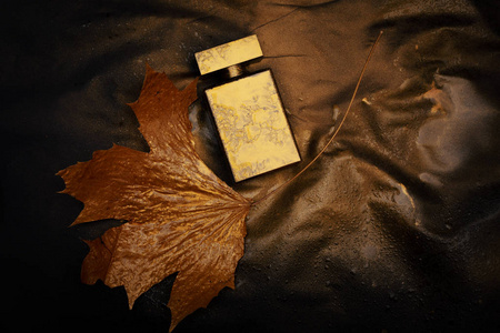gold perfume on dark background 