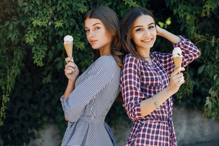 Elegant and stylish girls in a summer park