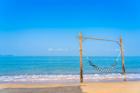 Empty hammock swing on the beautiful beach and sea