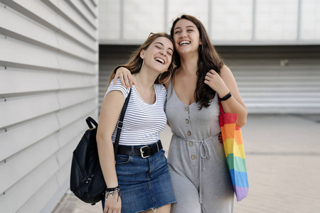 Pretty young couple of girls walking together and having fun in 