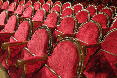 Empty vintage red wooden and velvet chairs