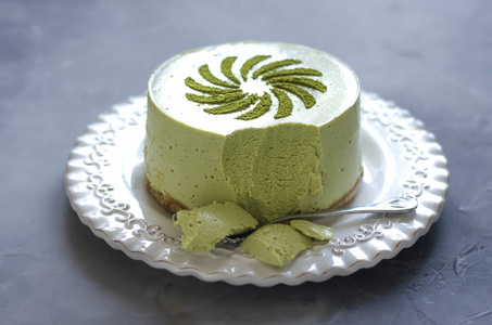 Cheesecake without baking with matcha tea on a white plate  