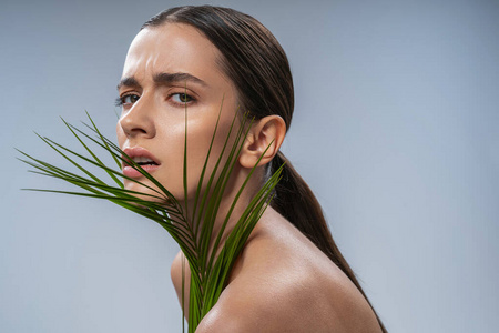 Emotional brunette woman making face on camera