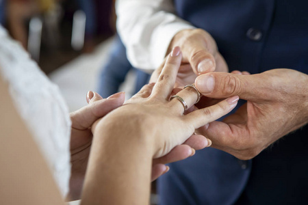 Groom Put the Wedding Ring on bride. Close up 