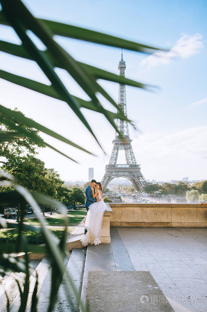 幸福浪漫的夫妇在埃菲尔铁塔附近拥抱