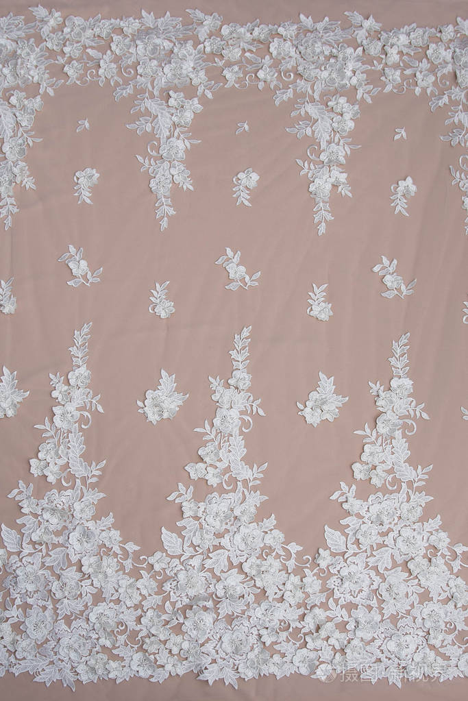 纱或线制成的薄织物.象牙色蕾丝布的背景图像.米色背景的白色蕾丝.