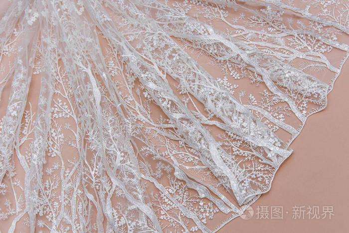 纹理蕾丝面料.白底花边工作室.纱或线制成的薄织物.象牙色蕾丝布的背