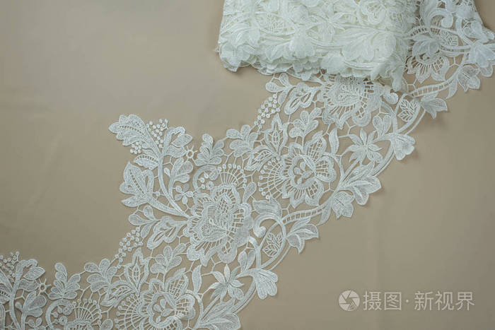 纹理蕾丝面料白底花边工作室纱或线制成的薄织物象牙色蕾丝布的背景