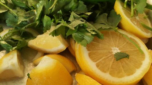 Top view of fresh lemon slices with green pepper cut into pieces