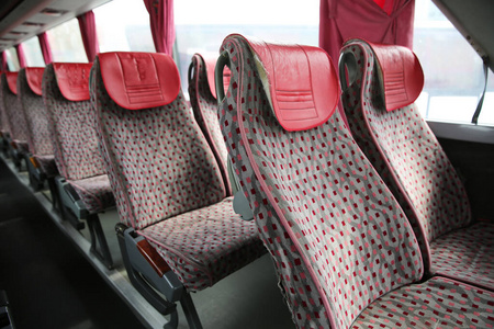 新型现代巴士的内饰。公共汽车安全带。坐在公交车内部，交通便利，出行舒适。新的现代红色椅子巴士的开放式双层内饰。