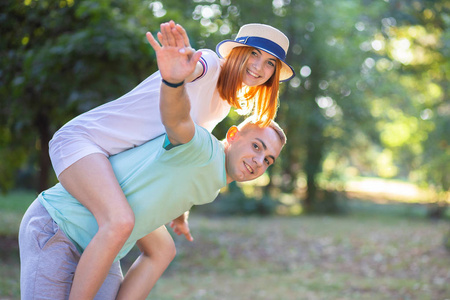 Happy young couple boyfriend and girlfriend having fun outdoors 