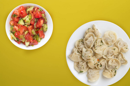  dumplings on a white plate on a colored background. Top view of