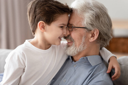 幸福的爷爷和小孙子抚摸鼻子,表达爱意照片