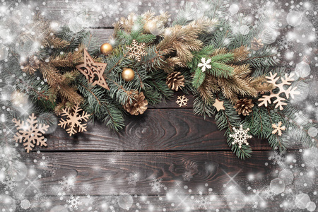 fir branches with Christmas decor on old dark wooden background 