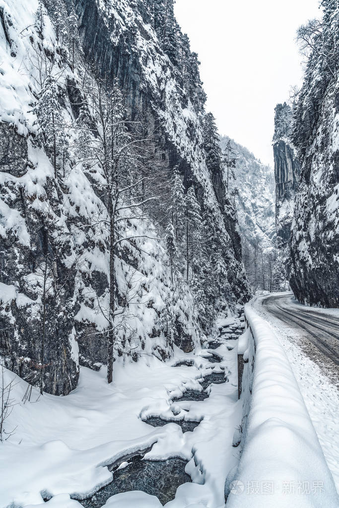 冬天积雪覆盖的山路雪白的云杉和岩石美丽的冬日景色旅行背景交通运输
