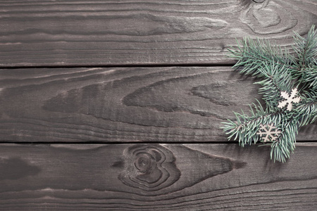 fir branches with Christmas decor on old dark wooden background 