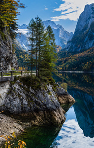 Peaceful autumn Alps mountain lake with clear transparent water 