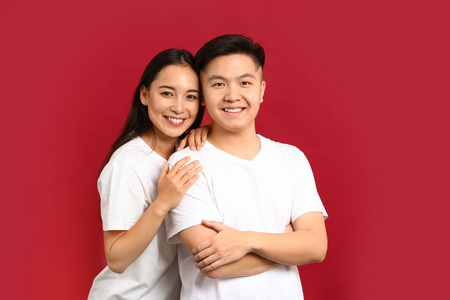 一对快乐的亚洲年轻夫妇的彩色背景肖像