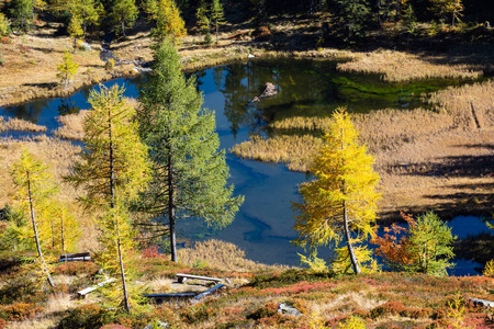 Calm autumn Alps mountain lake with clear transparent water and 