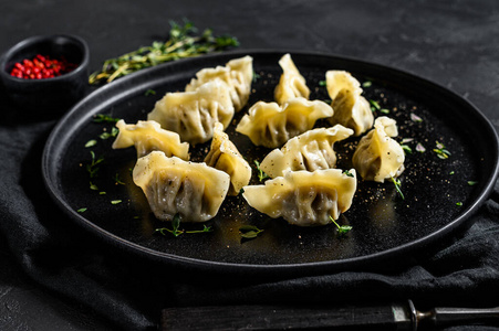 自制肉馅饺子。黑色背景。俯视图。文本空间