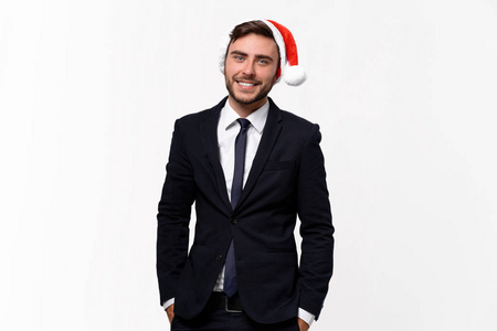 Young handsome caucasian guy in business suit and Santa hats sta