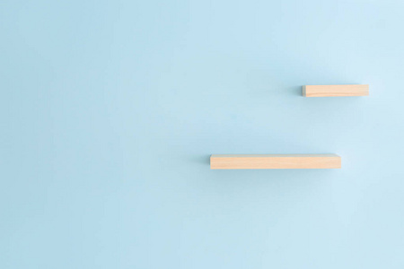 Empty shelves hanging on color wall