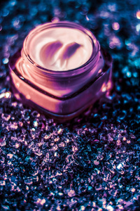 Luxury face cream for healthy skin on shiny glitter background, 