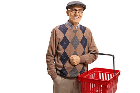 Elderly man smiling and holding a shopping basket 