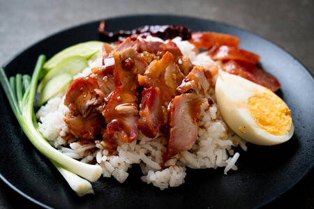 Barbecued red pork in sauce on topped rice 