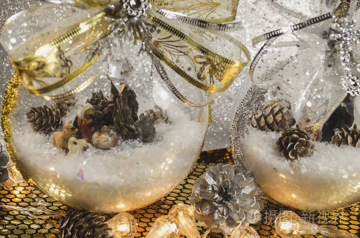 transparent Christmas balls filled with snow and with the birth 