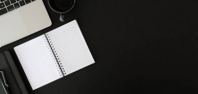 Top view of dark modern  room with open notebook with offi