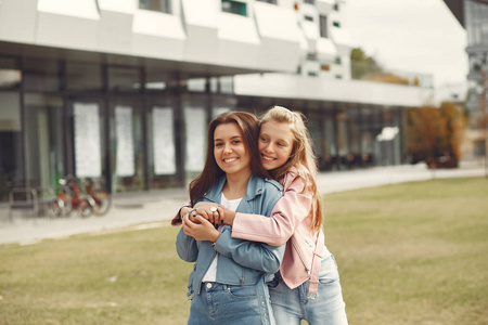 Elegant and stylish girls in a autumn park