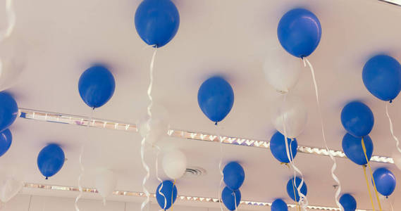 Blue and white color balloons in the room prepared for birthday 