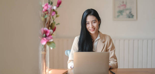 Portrait of young businesswoman working on her project with lapt