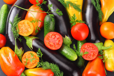 Assortment of fresh raw vegetables on black background. Tomato, 