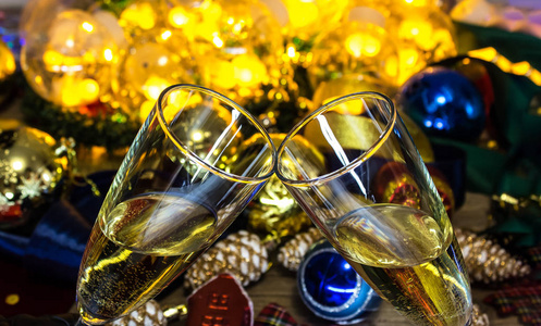 Glasses of champagne on the Christmas table with Christmas toys 