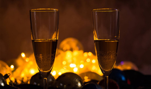 Glasses of champagne on the Christmas table with Christmas toys 