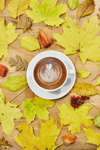 Autumn flat lay composition with dry leaves wreath frame and cof