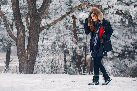 Elegant and young girl in a winter park