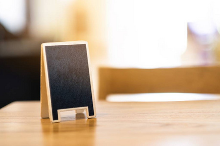 Mini chalkboard on table in cafe with copy space 